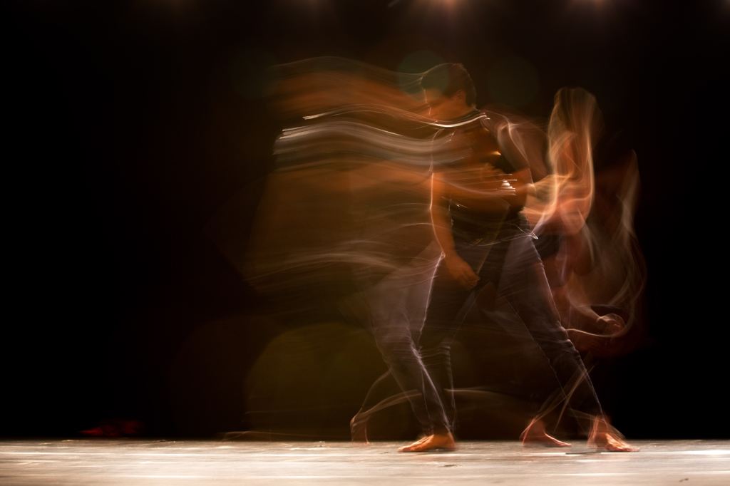 arts appointments. Image is a blurry shot of a dancer in motion.