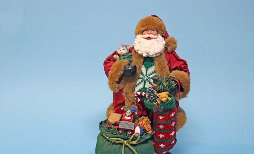 figurine of Father Christmas with a green sack overflowing with toys