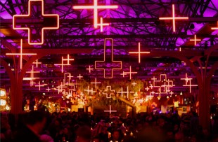 Dark Mofo. Hall filled with neon crosses and diners.