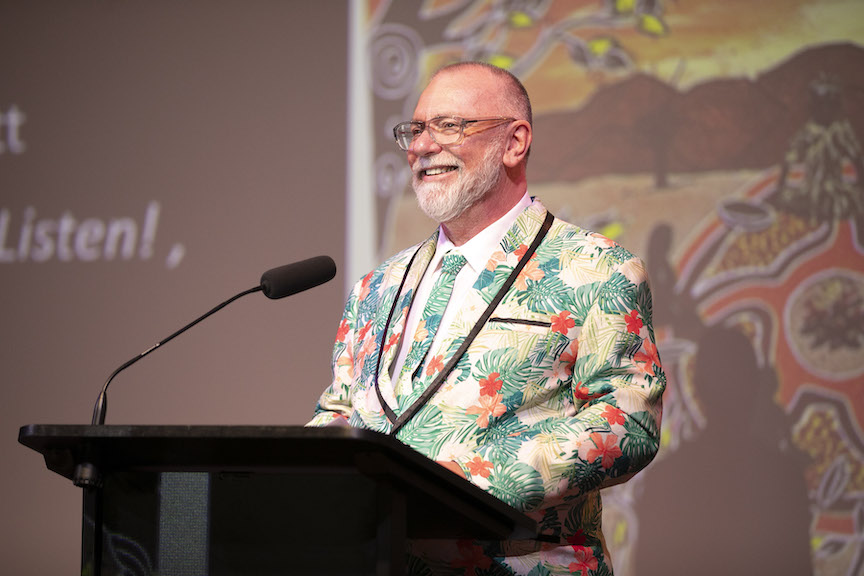 Man with beard and bright patterned jacket giving speech. Craig Donarski. powerhouse