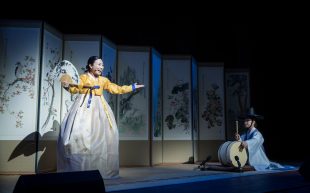 ‘Viva Korea’ at Riverside Theatres. Photo: Supplied. Two performers in traditional Korean dress on a stage set-up with large artistic screen dividers.