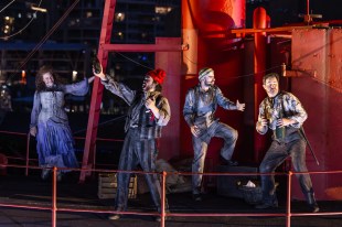 Il Tabarro. Four opera singers dressed in period nautical gear sing from the prow of a ship.