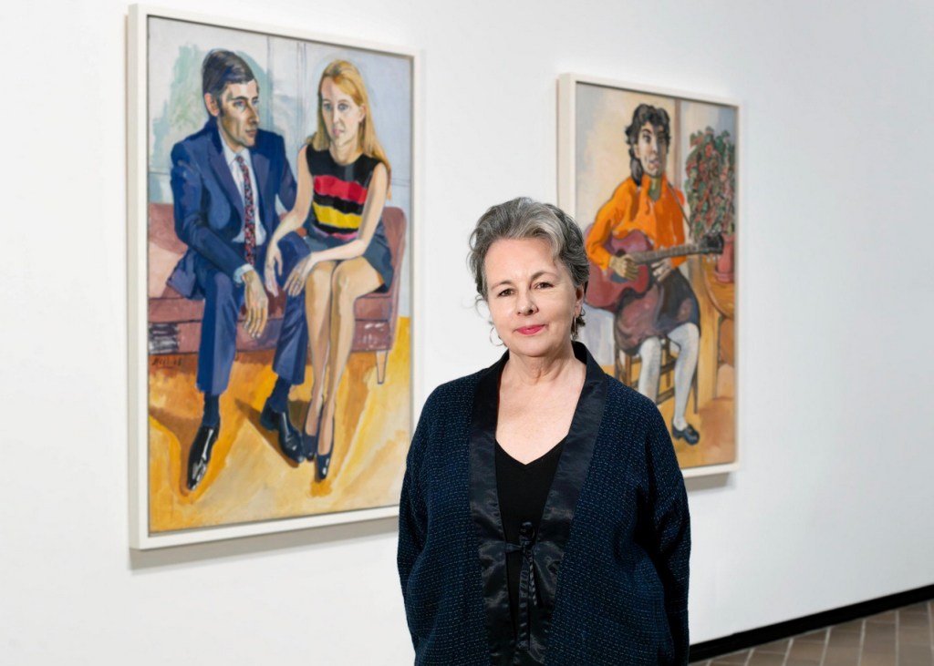 Podcast. Woman standing in front of artworks. Jennifer Higgie.