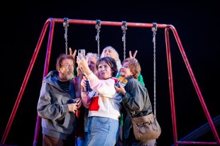 Seventeen. Five adults dressed and acting like teenagers gather around a swing set to take a joint selfie.