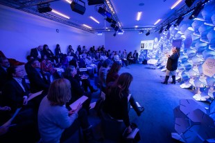 conference. audience gather and listen to speaker in blue lit room