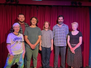 Australian Gothic Tales. Five men and women stand in front of a red curtain looking at the camera and smiling.