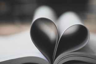 literary speed dating. Image is an open book with the pages folded in to make the shape of a heart.