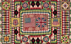Quilt work from the exhibition 'Quilts: The Fabric of War 1760-1900' at The David Roche Collection. Photo: Supplied. A harlequin quilt pattern with red, pink, yellow, blue green, white, purple and black diamond patches. It features various emblems, the US flag, the union jack and the words 'IN GOD WE TRUST'