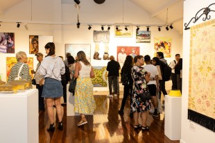 2024 Blacktown City Art Prize announces winners. Image: 2024 Blacktown City Art Prize, installation view. Photo: Liza Moscatelli, Mosca Media Australia. A buzzing crowd gathering in the gallery space filled with artworks on the walls and small sculptures on plinths.