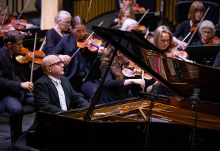 Alexander Gavrylyuk seated at a piano in concert.