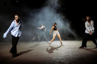 Four male and female performers in casual clothing dancing spot lit under smoky lights on an open stage. Coalescing Towards. Perth Festival