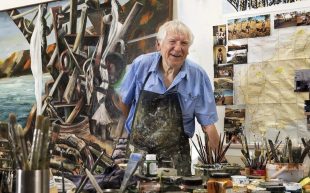 man with blue shirt in painting studio. Jan Senbergs.