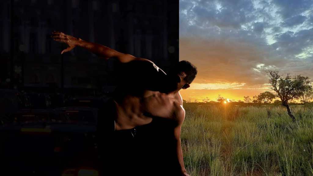 arts strategy. Bare-chested dancer leans to the right with his right arm up and out from his body. Behind him there is a distinct two halves to the backdrop, pitch black on the left and an outback sunset scene on the right.