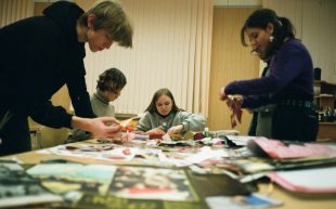 Photo: Maria Varshavskaya, Pexels. A group of young people sitting and standing next to a table with scrapbooking material laid out.