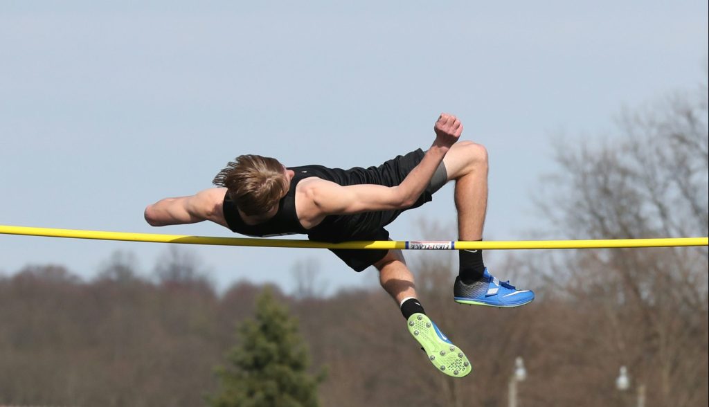 A dynamic image of a high-jumper caught mid-leap over the bar.