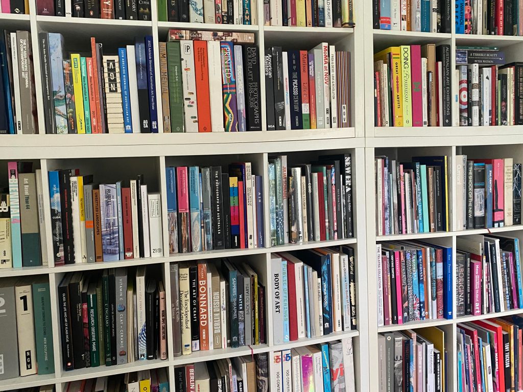 art books. Image is a five shelves full of art books, filling the entire frame.