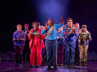 LPA's proposed Live Theatre Tax Offset would support the presentation of works like 'Groundhog Day the Musical', which is now playing at Melbourne's Princess Theatre, Photo: Visit Victoria. Photo of the cast performing in ‘Groundhog Day’ musical. At the centre is a character with brown skin, long curly brown hair who appears to be singing.