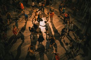 An overhead shot of a large group of couples dancing together.