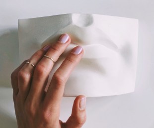 Tactile tours. Image is a hand touching the lips of a plaster cast of the bottom half of a face.