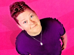 MICF 2024. Kirsty Webeck. Image is shot of a woman with short curly-ish hair wearing a purple T shirt and a pendant and smiling up at the camera, which is positioned overhead. There is a pink background.