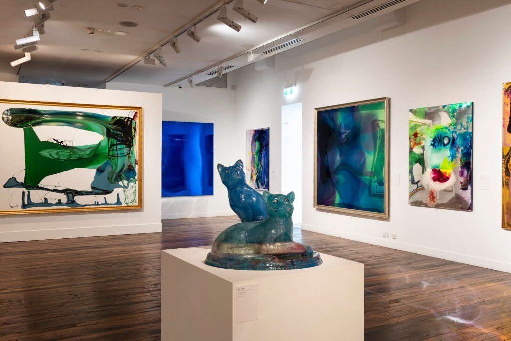 blue cat sculpture and abstract paintings in gallery. Dale Frank