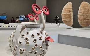 Works shown as part of ‘LOEWE Crafted World’ at Shanghai Exhibition Centre. Ceramic chestnut roasters by Laia Arqueros. Photo: ArtsHub. A playful pair of ceramic chestnut roasters with eyes and a tongue poking out. It’s placed on a large exhibition platform alongside other objects on display.