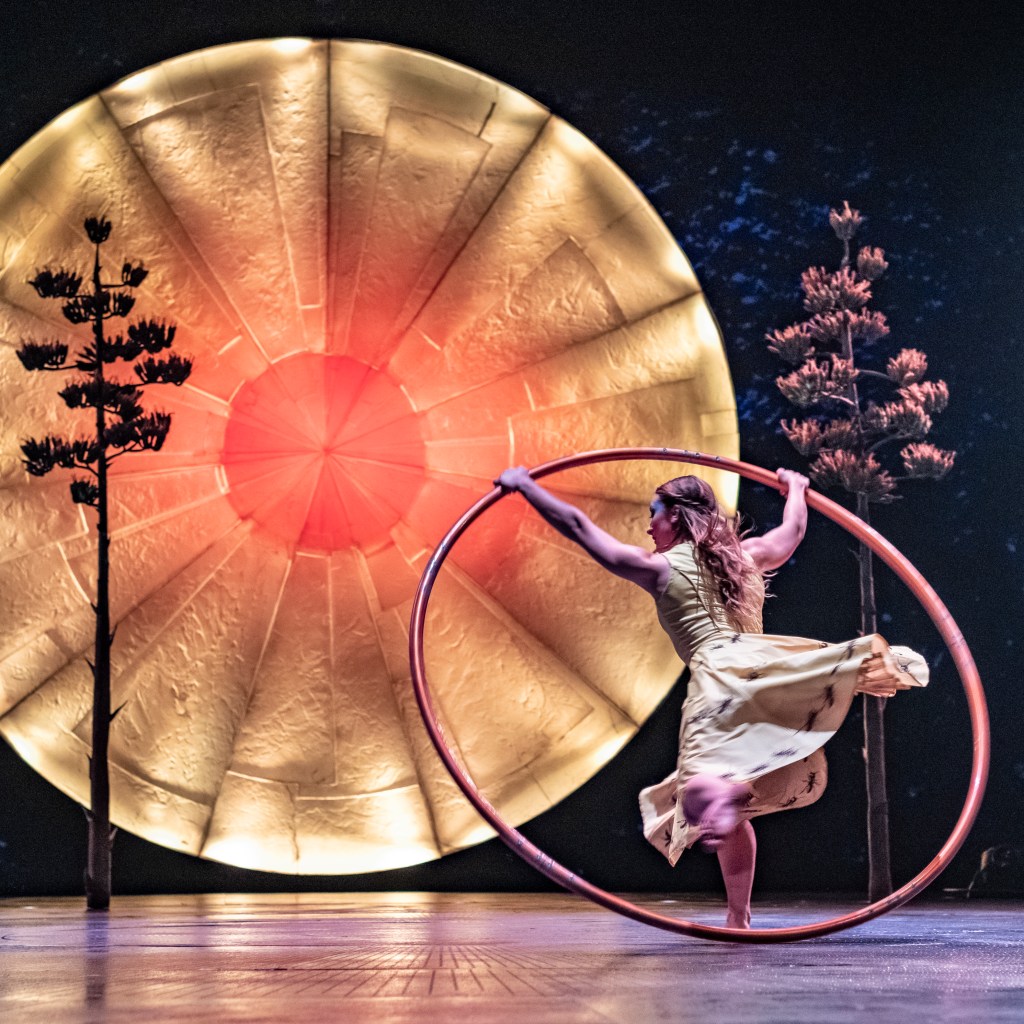 Luzia Cirque du Soleil. A woman swirls around a stage in a large hoop.