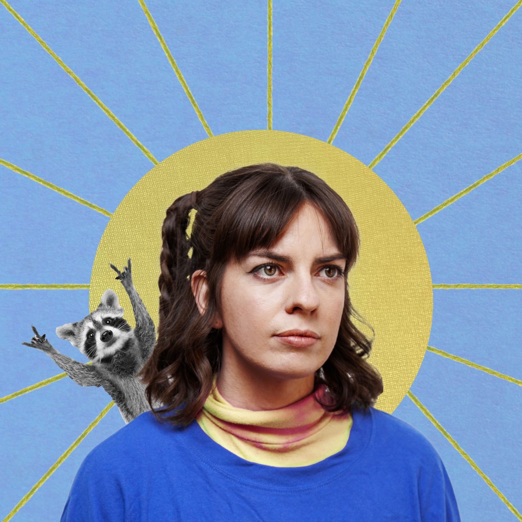 MICF 2024 Emma Holland. Image is a blue background with a radiant sun in the middle, obscured by a young woman, who is wearing a blue jumper over an apricot roll neck top. She has a plait on the left hand side of her head and a racoon waving over her shoulder.