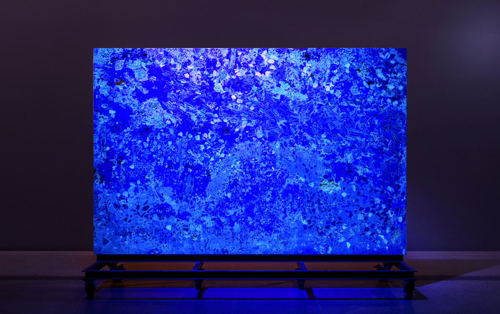 Blue minimal artwork in darkened gallery. Nicholas Mangan.