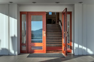 Two wooden doors at the Museum of Australian Democracy, one open.