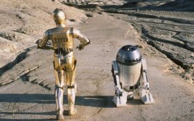 Star Wars: Return of the Jedi. A golden android known as C3PO walks along a road track aside a short robot known as R2D2.