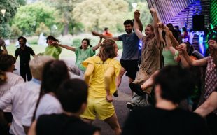 Deep Soulful Sweats at Next Wave’s All School Lab 2024. Photo: Supplied. Wearing wearing t-shirts of different colours gathering in an area and throwing their arms in the air to the beat.