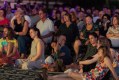 NT Writers Festival, Darwin. Large group of people sitting on the ground listening to something or someone we can't see.