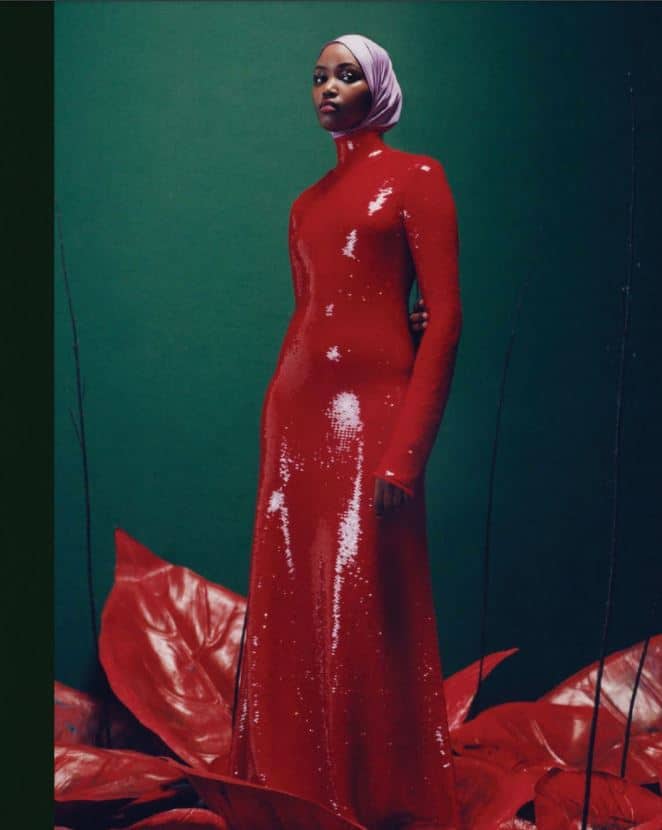 gallery gift shop. Image is a tall woman in a figure hugging red shiny dress.