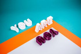 a brightly coloured photograph of #D block lettering that spells: "You are" in white letters, and "You" in dark red letters.