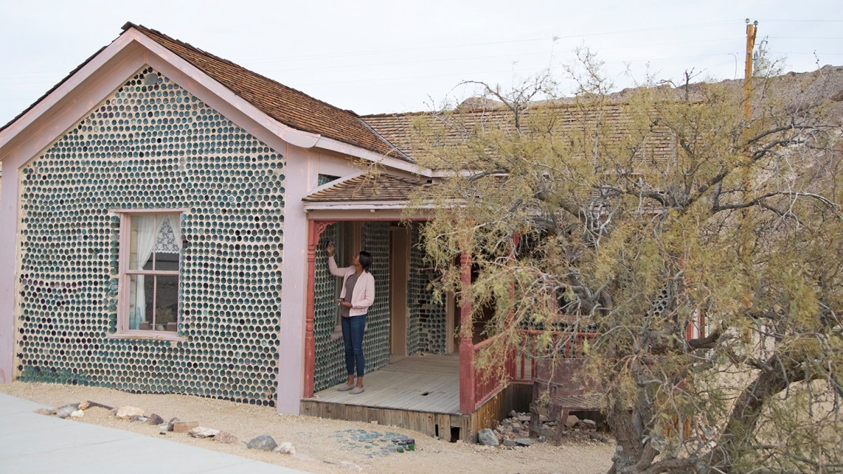 Nevada Art Trail. A house made of bottles with a woman touching the wall