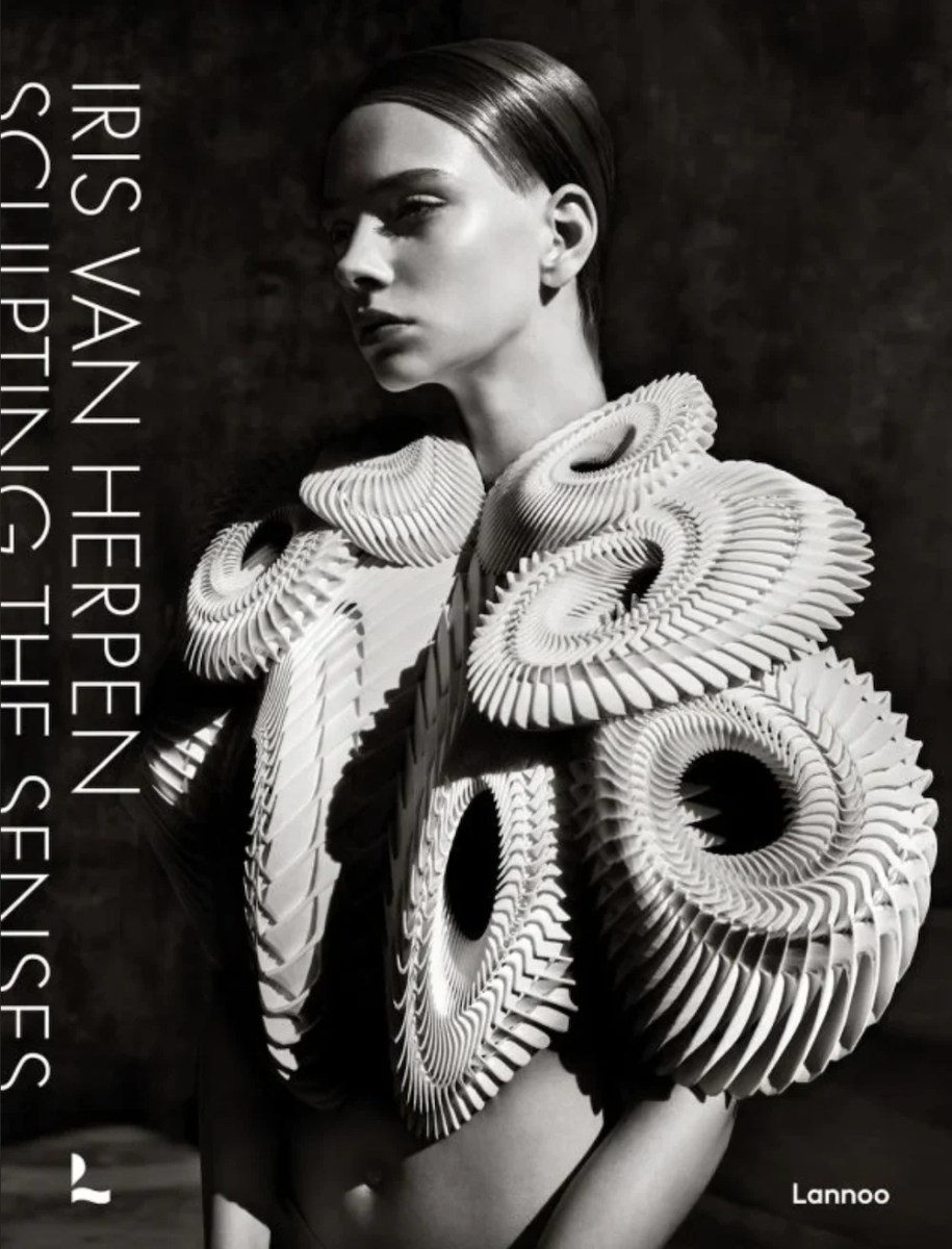 Black and white book cover with female fashion model wearing sculptural spiral top