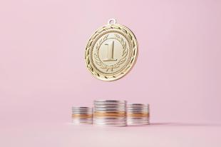 A pale pink background. There is a large gold coin with the number 1 on it hanging above three piles of coins.