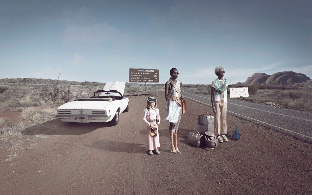 Galleries participating in Melbourne Art Fair 2025. Michael Cook (Jan Murphy Gallery), ‘Fake (Broken Down)’, 2023. A photographic work that appears to capture a scene where a car has broken down on the side of the road and two First Nations figures are standing beside a pale-skinned little girl with their luggage.