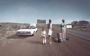 Galleries participating in Melbourne Art Fair 2025. Michael Cook (Jan Murphy Gallery), ‘Fake (Broken Down)’, 2023. A photographic work that appears to capture a scene where a car has broken down on the side of the road and two First Nations figures are standing beside a pale-skinned little girl with their luggage.