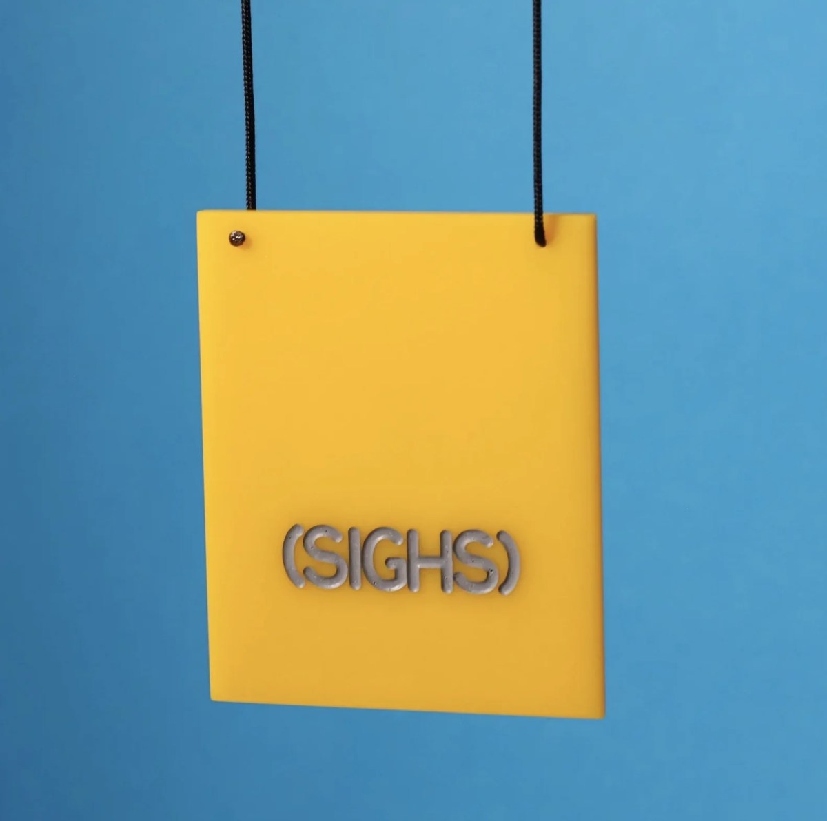 necklace of yellow acrylic square with text. Zoe Brand