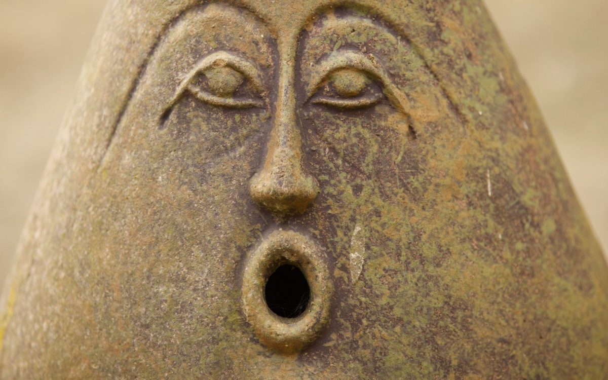 A photo of a sculptured object with a surprise expression on its face.