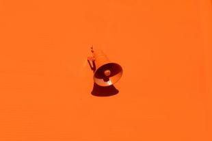 This week’s arts news and trending topics. The image depicts a plastic orange megaphone against an orange background.
