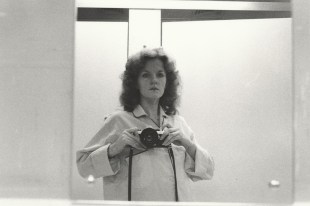 Black and white image of a women in 1970s taking self portrait. Carol Jerrems