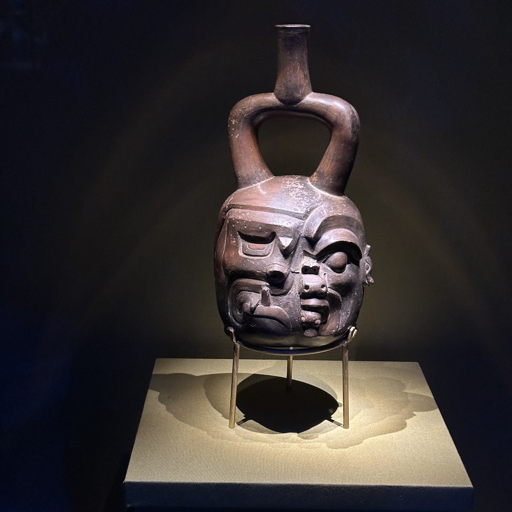 Pottery in museum display of human face becoming an animal. Machu Picchu