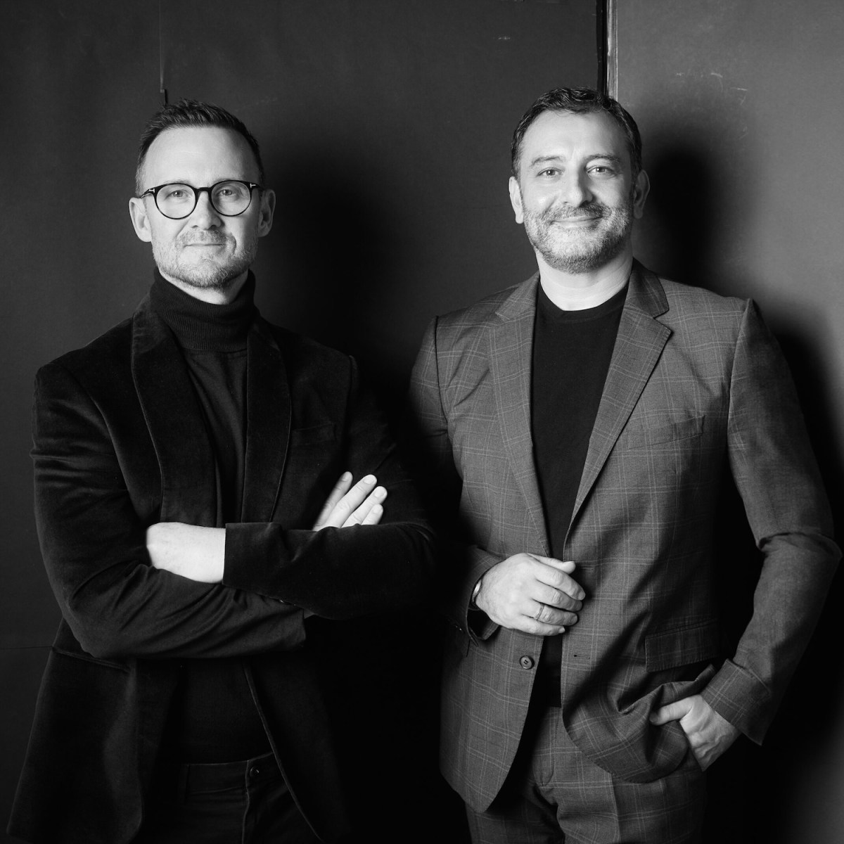 Two men in suits black and white photo. Ames Yavuz