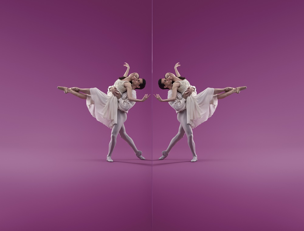 ballet companies: a male-female ballet pas de deux posing in a white tutu costume against a bright pink backdrop. Their pose is mirror imaged on each half of the photo.