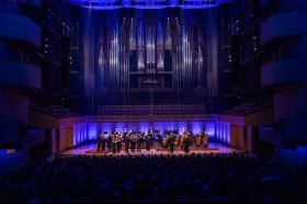 A classical concert with musicians on stage.