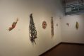 A range of colourful sculptures are affixed on the wall.