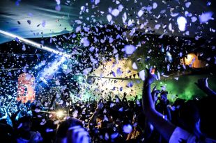 On the move is ArtsHub's weekly round-up of Australian arts appointments and resignations. The photo shows a crowd of people dancing at a rave party inside a nightclub.